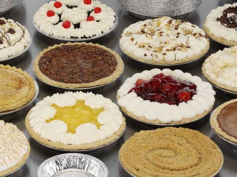 a wide variety of pies being displayed in handi-foil pie tins