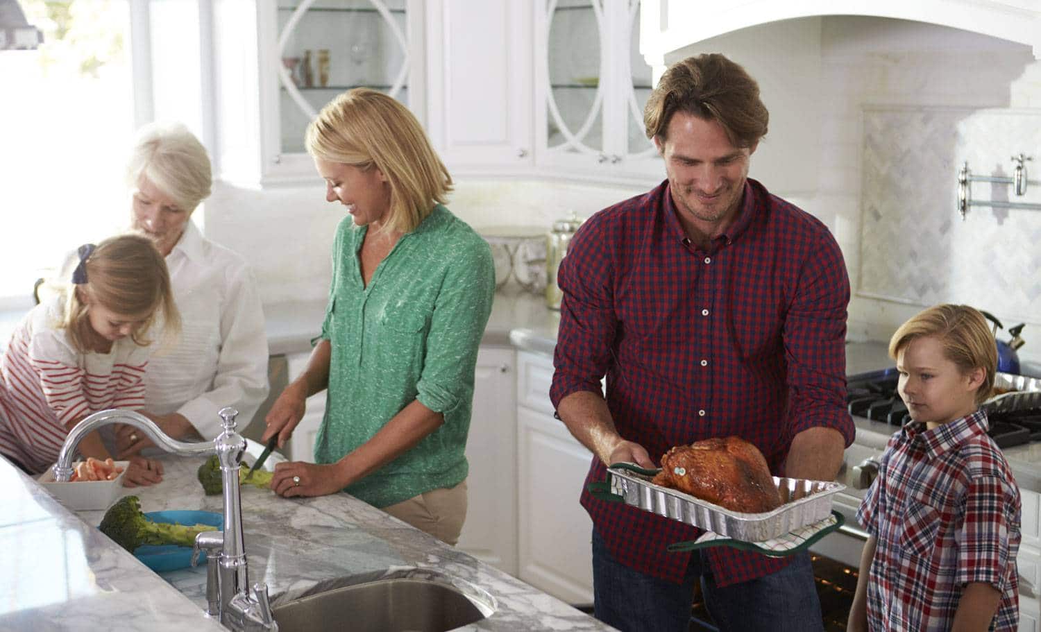 Family with a pan getting ready for dinner