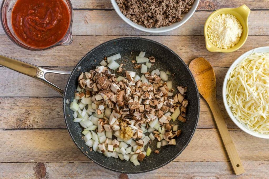 Easy Beef Lasagna in progress with onion garlic and mushrooms