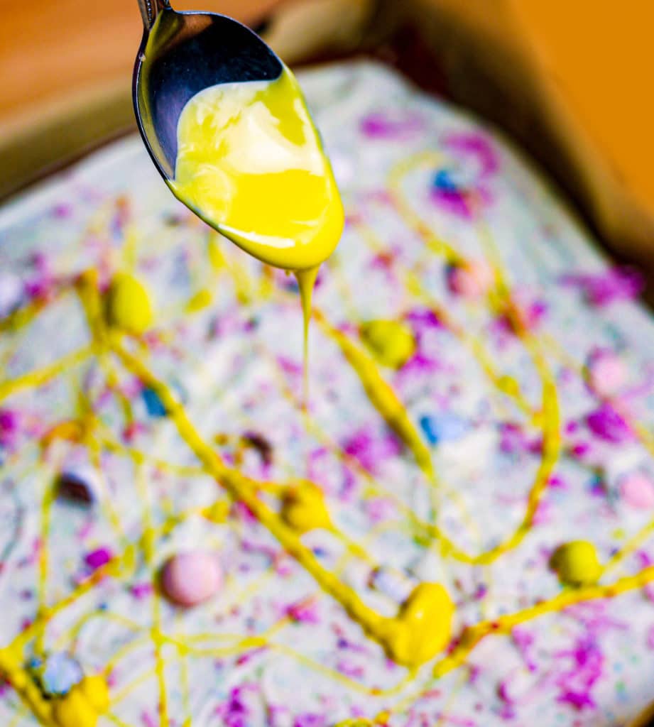 Yellow frosting dripping on cake